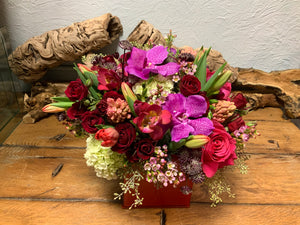 Holiday Vacation- Red Spray Roses, Vanda Orchids and Mini Green Hydrangea in a Red Cube Vase