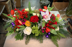 Christmas centerpiece with orchids, oranges and ornaments